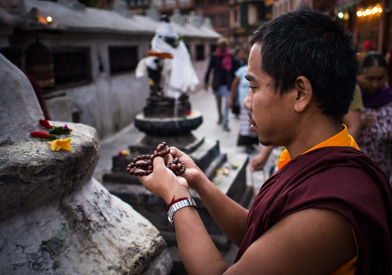 A Buddhist monk prays at the Boudhanath Stupa temple in Kathmandu, Nepal.