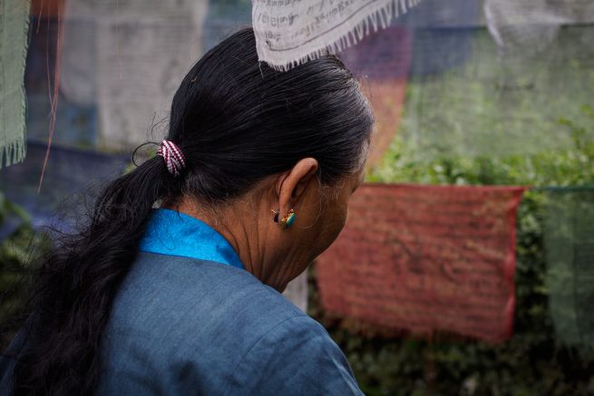 A Buddhist in deep prayer at Boudhanath stupa.