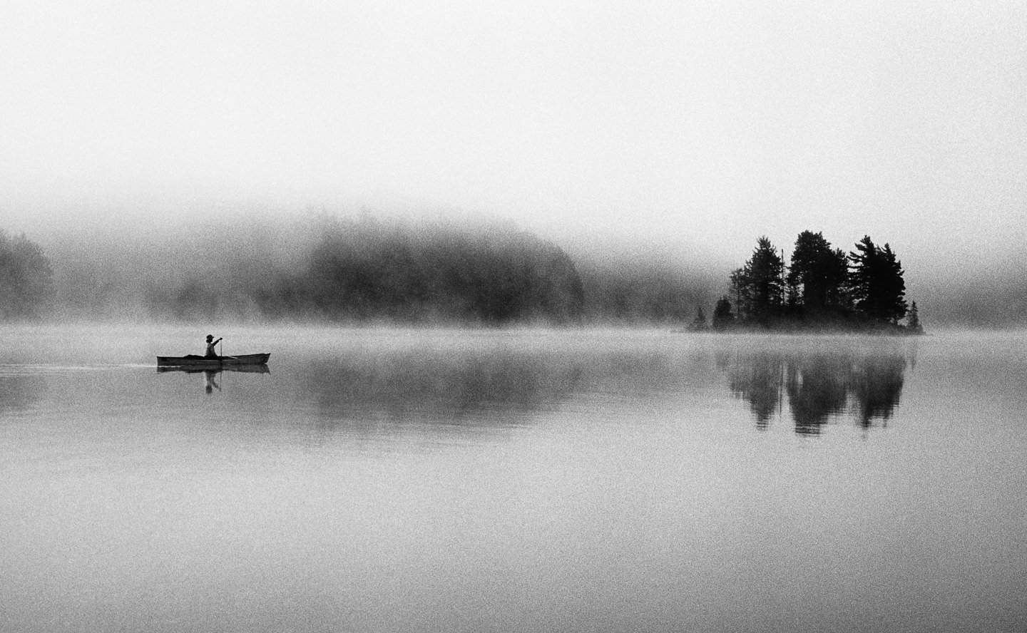 A paddler in the morning mist in Algonquin Provincial Park, Ontario.