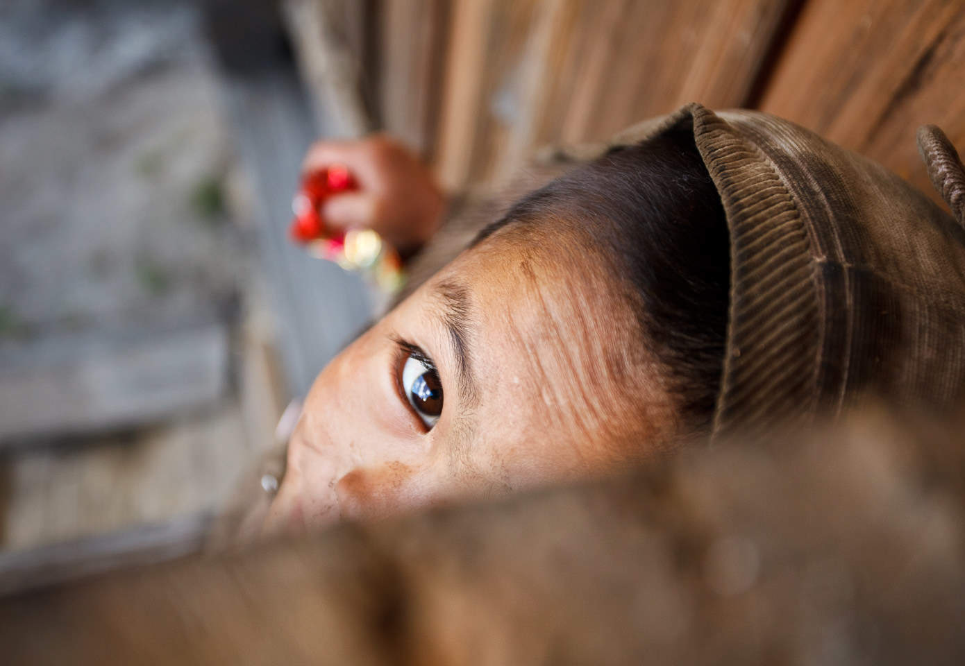 Boy playing peek-a-boo, eastern Nepal.