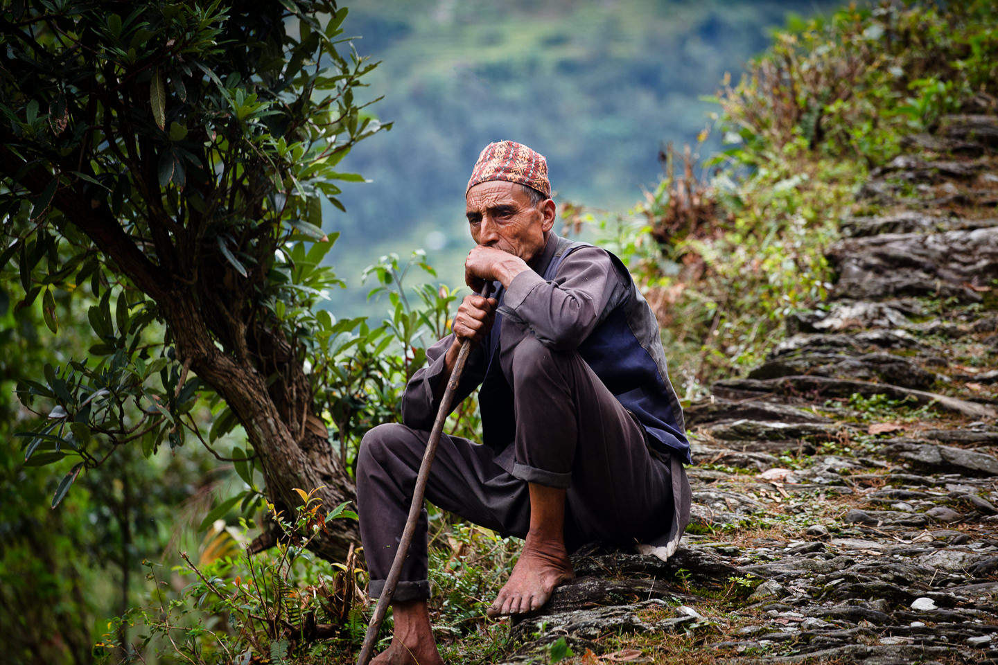 Nepali man resting on the path.